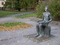 Bronzeskulptur Lesender Knabe von Siegfried Krepp und Gertrud Claasen aus dem Jahr 1974 im Park am Kreuzpfuhl im Munizipalviertel in Berlin-Weißensee
